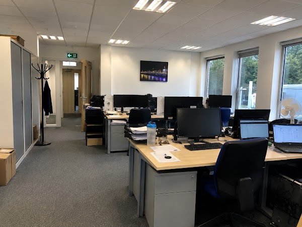 Spotless open-plan office workspace with rows of clean desks